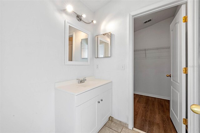 bathroom featuring vanity and hardwood / wood-style floors