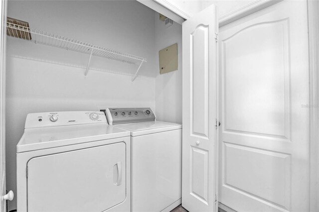 laundry area with washing machine and clothes dryer