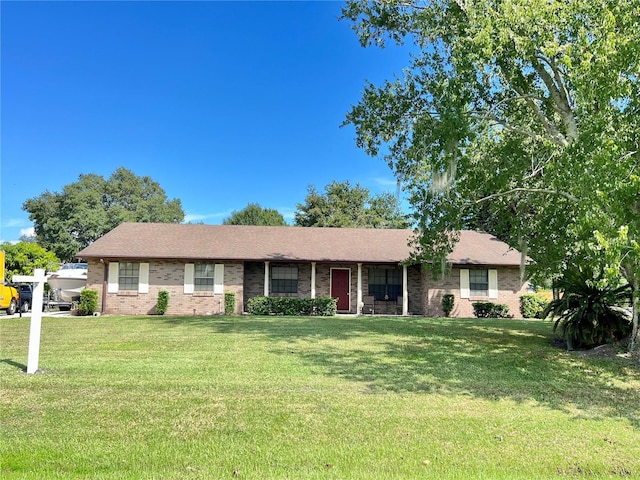 ranch-style home with a front lawn