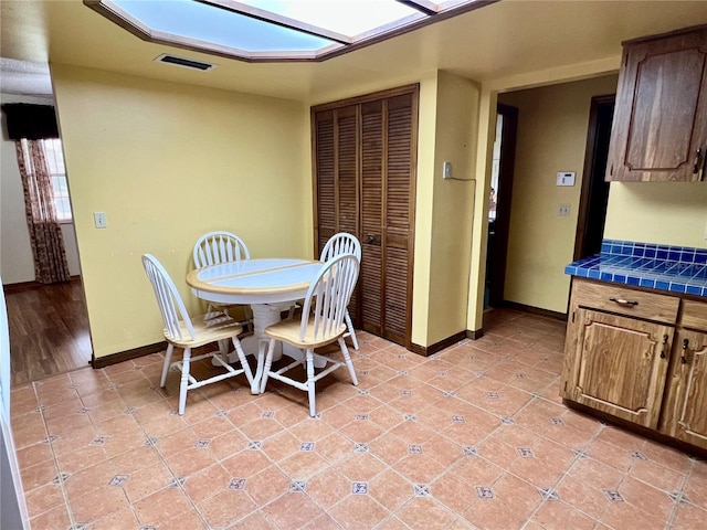 dining area with light tile patterned floors