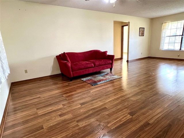 sitting room featuring a textured ceiling, ceiling fan, and dark hardwood / wood-style flooring