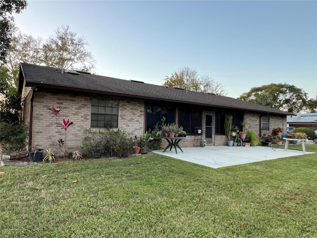 rear view of property with a patio and a yard