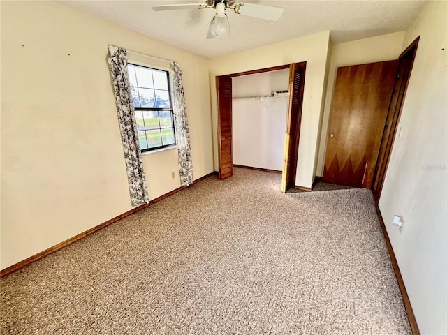 unfurnished bedroom with ceiling fan, a textured ceiling, a closet, and carpet floors