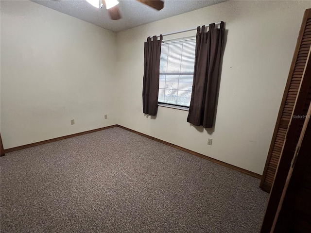 unfurnished room featuring a textured ceiling, carpet floors, and ceiling fan