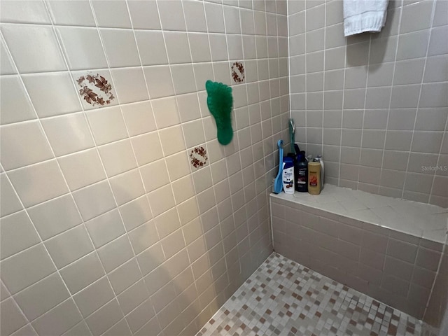 bathroom with tiled shower