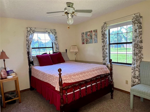 bedroom featuring ceiling fan, a textured ceiling, and carpet floors