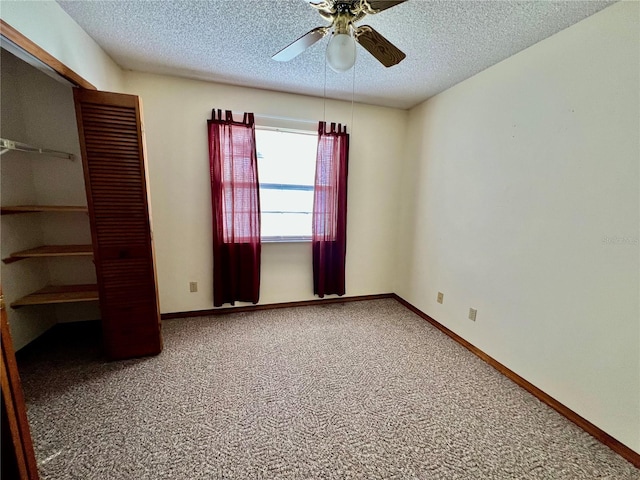 unfurnished bedroom featuring carpet floors, a textured ceiling, and ceiling fan