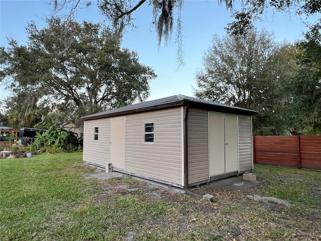 view of outbuilding featuring a yard