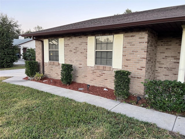 view of side of property with a yard