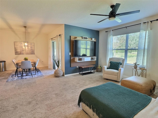 carpeted bedroom with ceiling fan and a textured ceiling