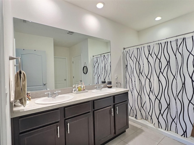 bathroom featuring shower / bath combo with shower curtain, tile patterned flooring, and vanity