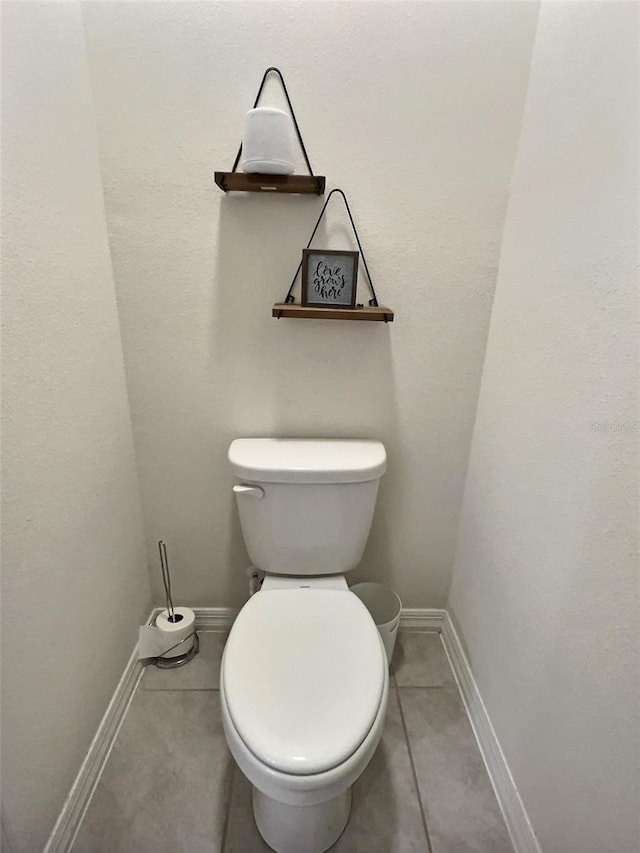 bathroom with tile patterned flooring and toilet