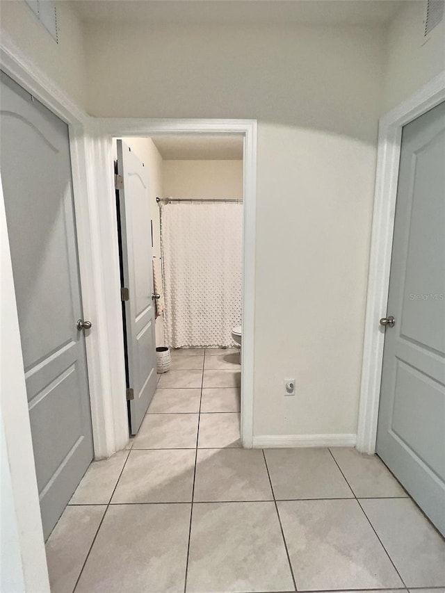 corridor featuring light tile patterned flooring