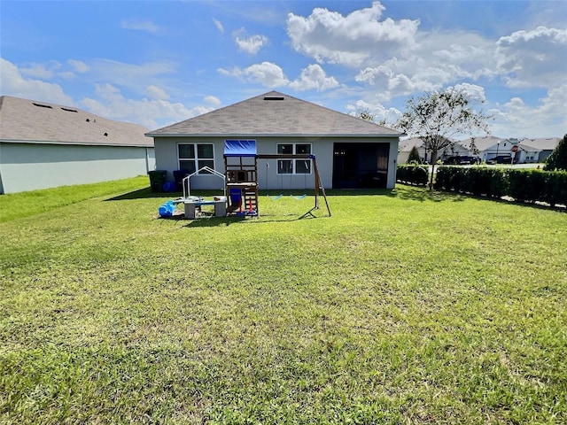 rear view of property with a lawn