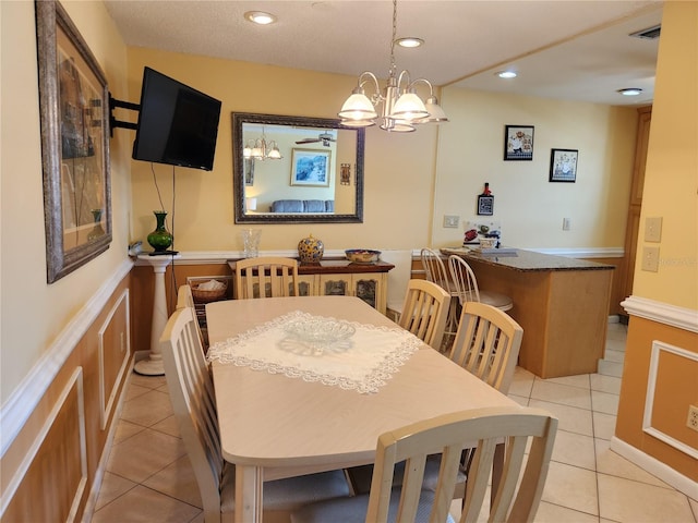 dining room featuring ceiling fan with notable chandelier and light tile patterned floors