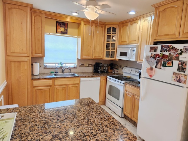 kitchen with ceiling fan, light tile patterned floors, sink, white appliances, and dark stone counters