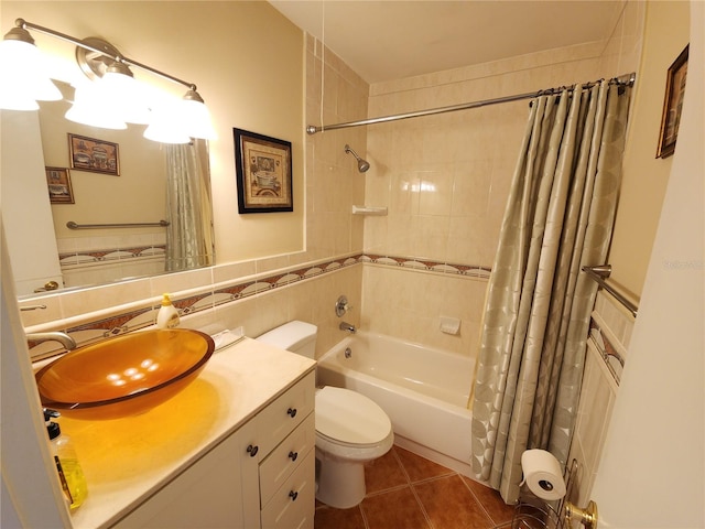 full bathroom with tile walls, shower / tub combo, vanity, toilet, and tile patterned floors