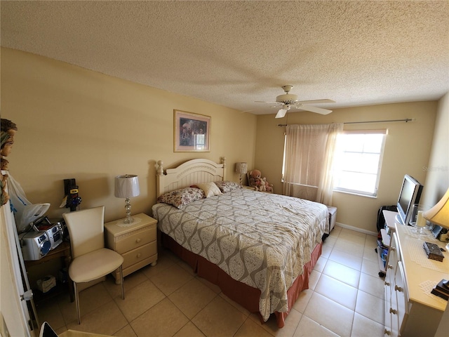 tiled bedroom featuring ceiling fan and a textured ceiling