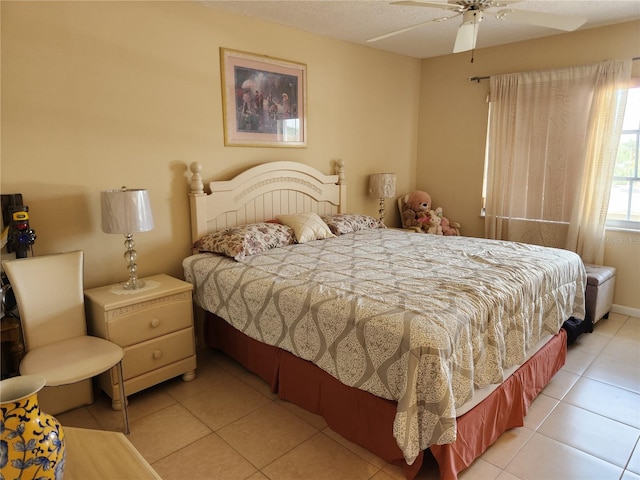 tiled bedroom featuring ceiling fan