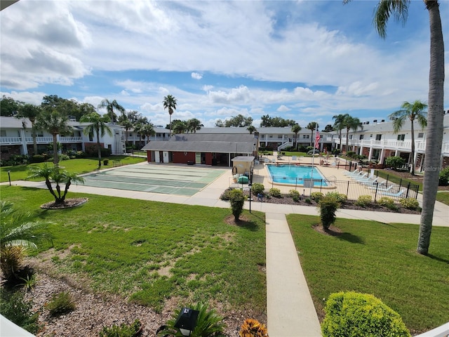 view of swimming pool featuring a lawn and a patio area