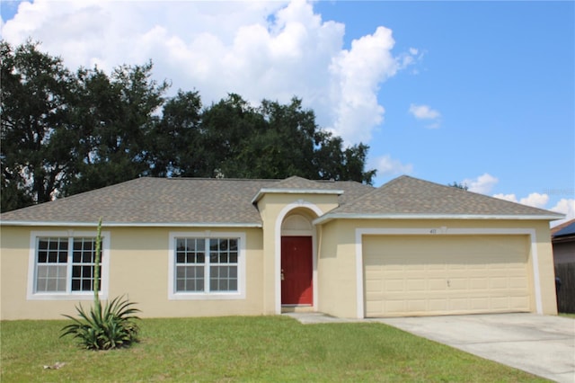 single story home with a garage and a front lawn