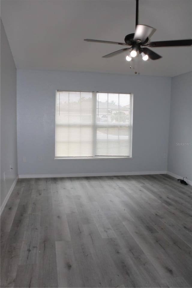 spare room featuring ceiling fan and hardwood / wood-style flooring