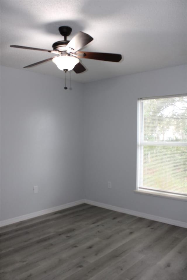 spare room with ceiling fan and dark hardwood / wood-style flooring