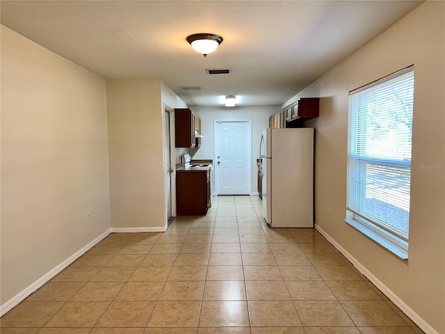 kitchen with white appliances and light tile patterned floors