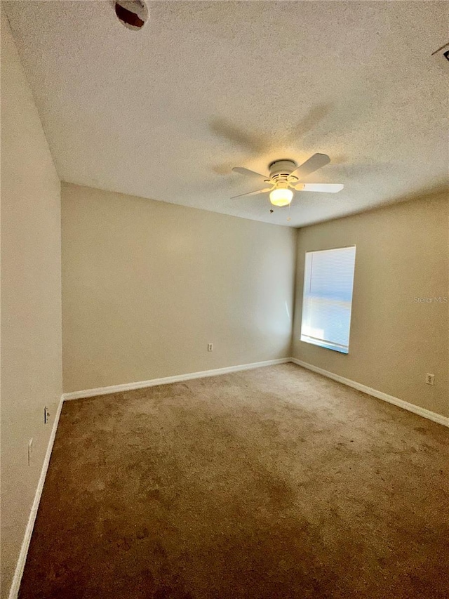 carpeted empty room with a textured ceiling and ceiling fan