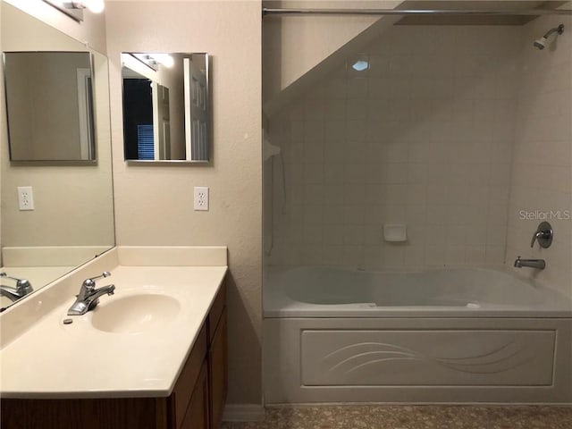 bathroom with vanity and tiled shower / bath