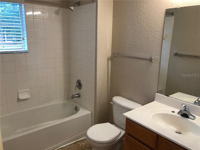 full bathroom featuring vanity, toilet, and tiled shower / bath