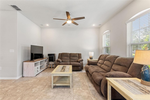 tiled living room featuring ceiling fan