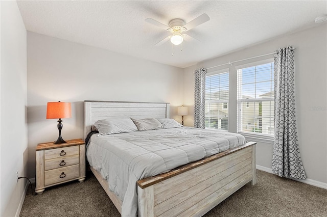 carpeted bedroom with ceiling fan and a textured ceiling