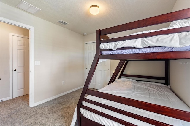 unfurnished bedroom with a closet, carpet, and a textured ceiling