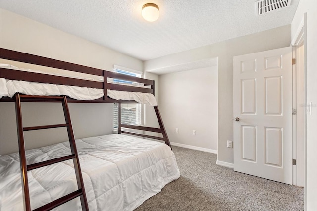 unfurnished bedroom featuring a textured ceiling and carpet