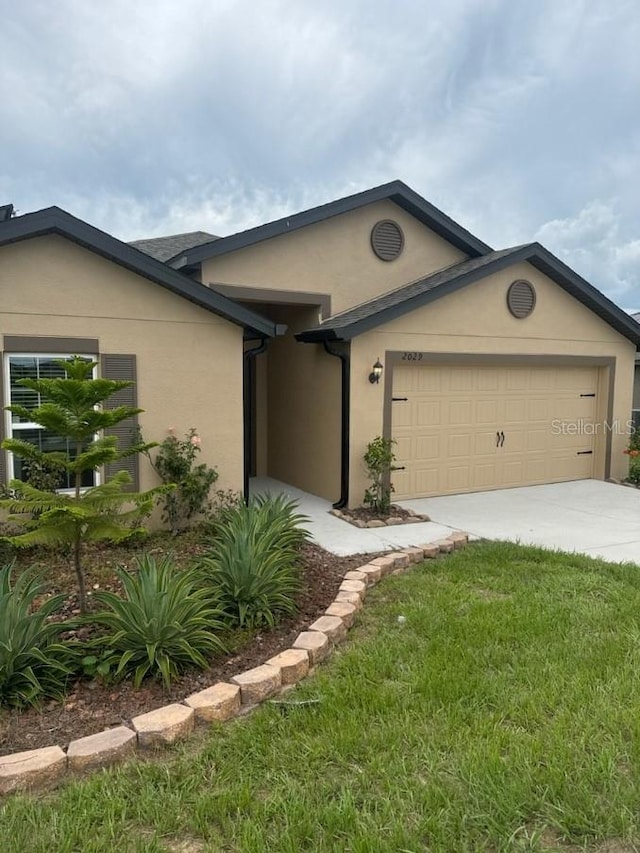 ranch-style home with a front lawn and a garage