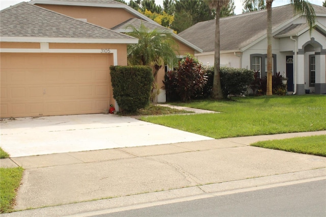 view of front facade featuring a garage and a front yard