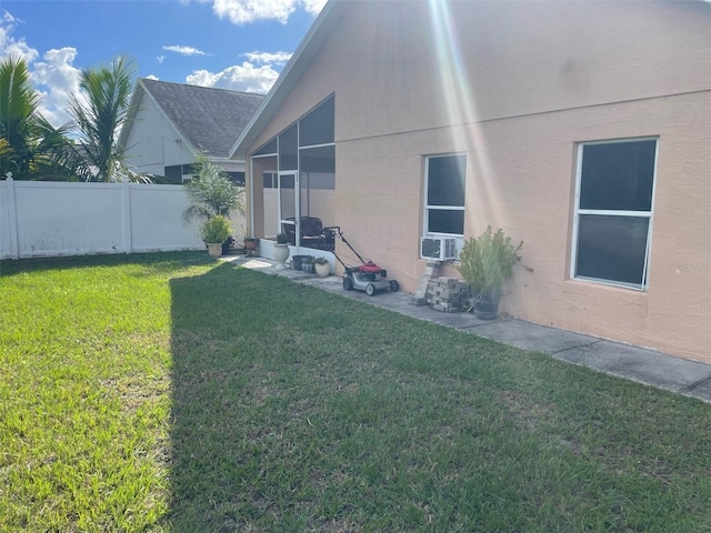 rear view of property with cooling unit and a yard