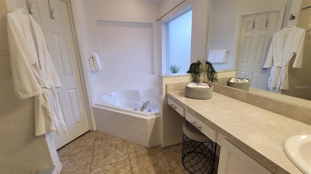 bathroom with vanity, a relaxing tiled tub, and tile patterned flooring