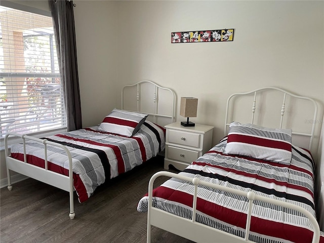 bedroom with dark hardwood / wood-style flooring