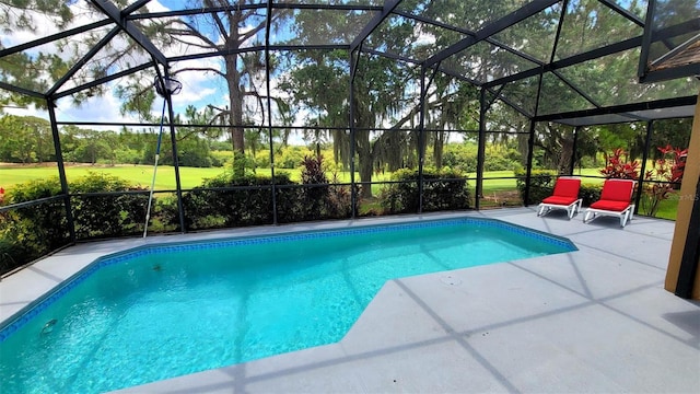 view of swimming pool featuring a patio area and glass enclosure