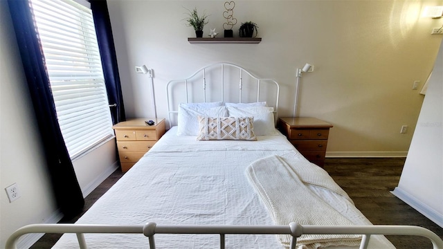 bedroom with dark hardwood / wood-style floors