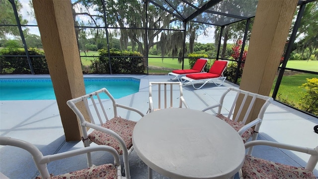 view of swimming pool with a patio and glass enclosure