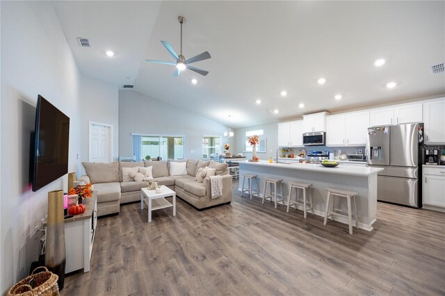 872 Sydney St, Davenport, FL 33837 - living room with high vaulted ceiling, ceiling fan, recessed lighting, and wood finished floors