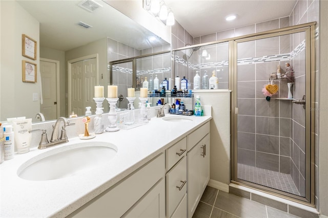 bathroom with vanity, tile patterned floors, and a shower with door