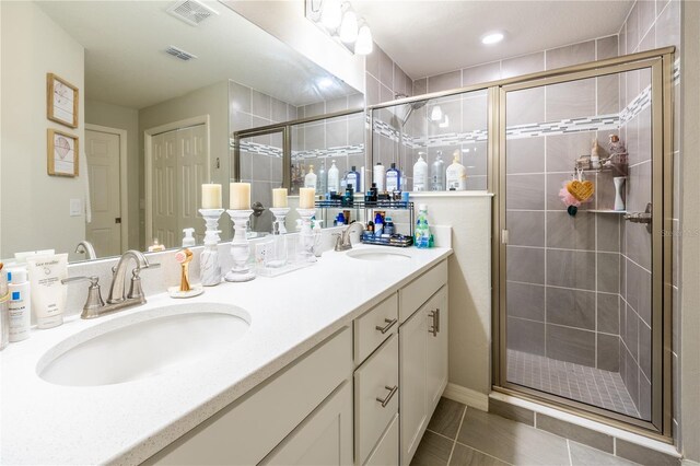 872 Sydney St, Davenport, FL 33837 - bathroom with a stall shower, double vanity, and tile patterned flooring