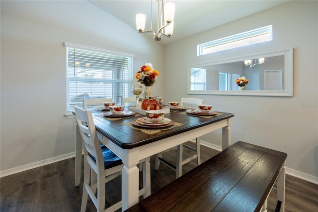 872 Sydney St, Davenport, FL 33837 - dining space with a chandelier, wood finished floors, baseboards, and lofted ceiling