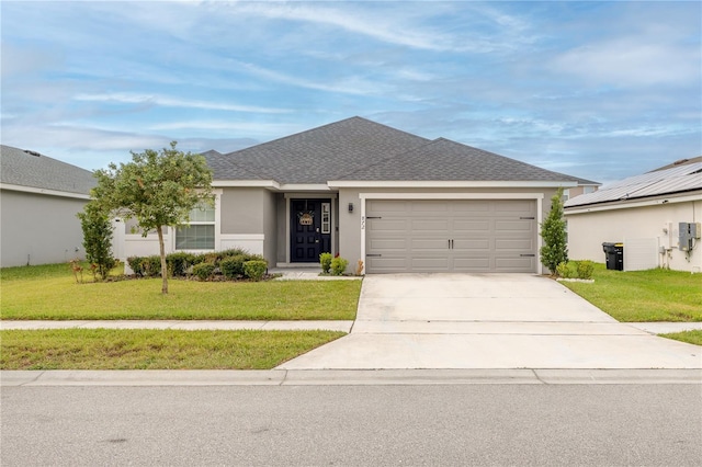 ranch-style home featuring a garage and a front yard