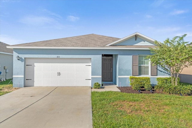 ranch-style home with a garage and a front yard