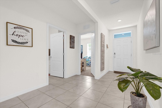 entryway with light tile patterned floors